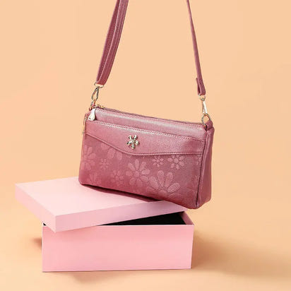 Floral-patterned, mauve crossbody bag.