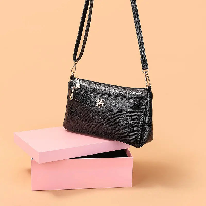 Black floral-patterned shoulder bag.