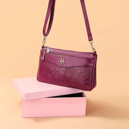 Maroon floral-patterned shoulder bag.