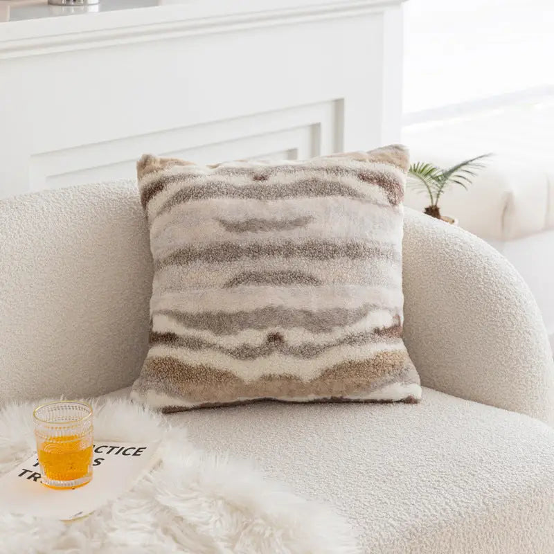 Striped faux fur pillow on vintage knotted cushion for cozy vintage decor