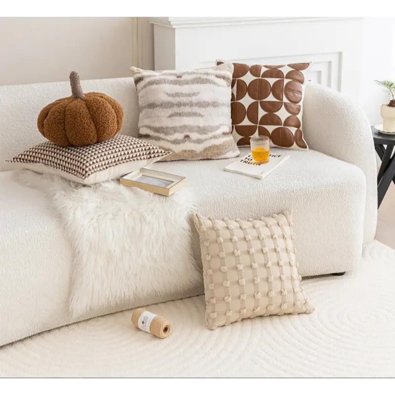 Assorted decorative pillows on a couch showcasing the vintage knotted cushion design