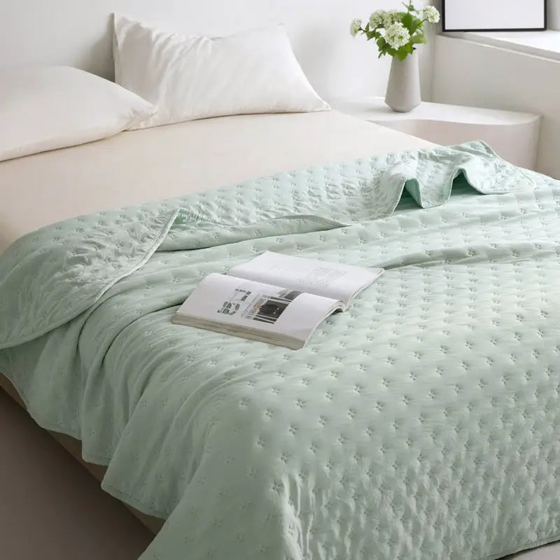 Mint green quilted bedspread.