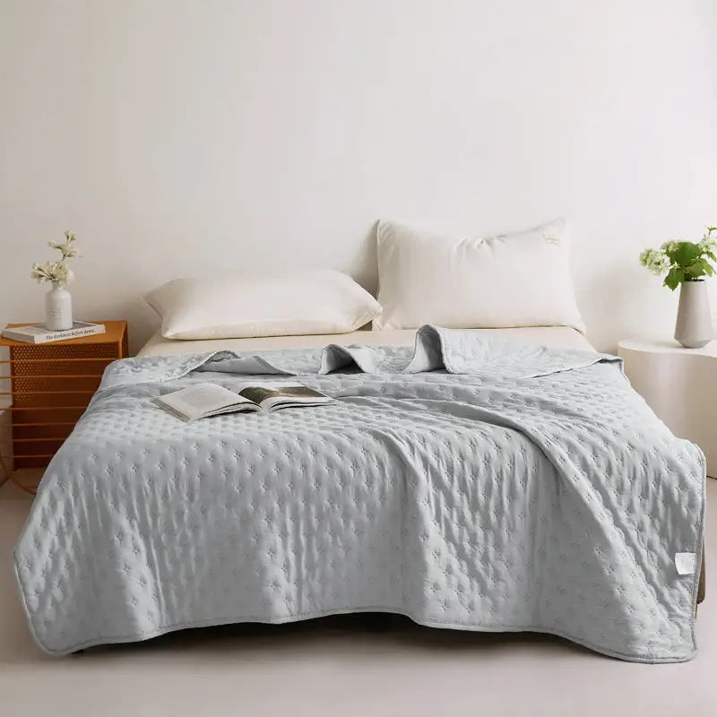 Light blue textured bedspread.