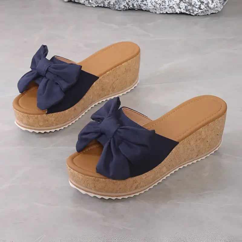 Wedge sandals with navy bow.