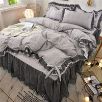 Gray ruffled bedding set.