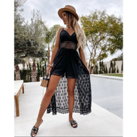 Woman in black lace romper with straw hat.