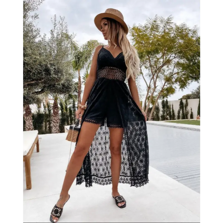 Woman in black lace romper with straw hat.