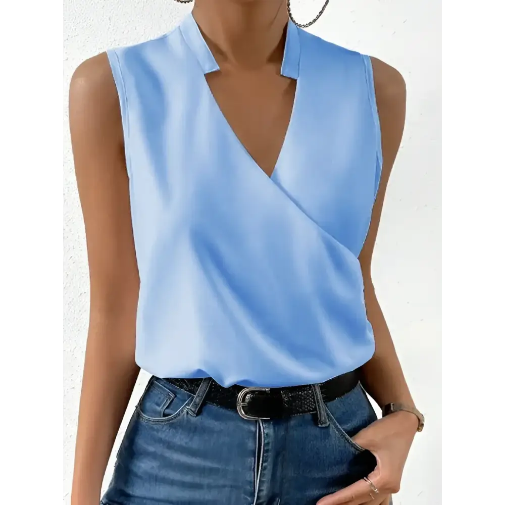Light blue sleeveless wrap blouse.