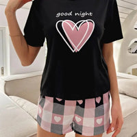 Black pajama set with pink hearts.