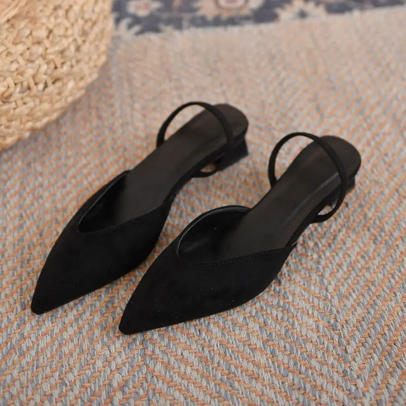 Pair of black pointed-toe slingback heels.