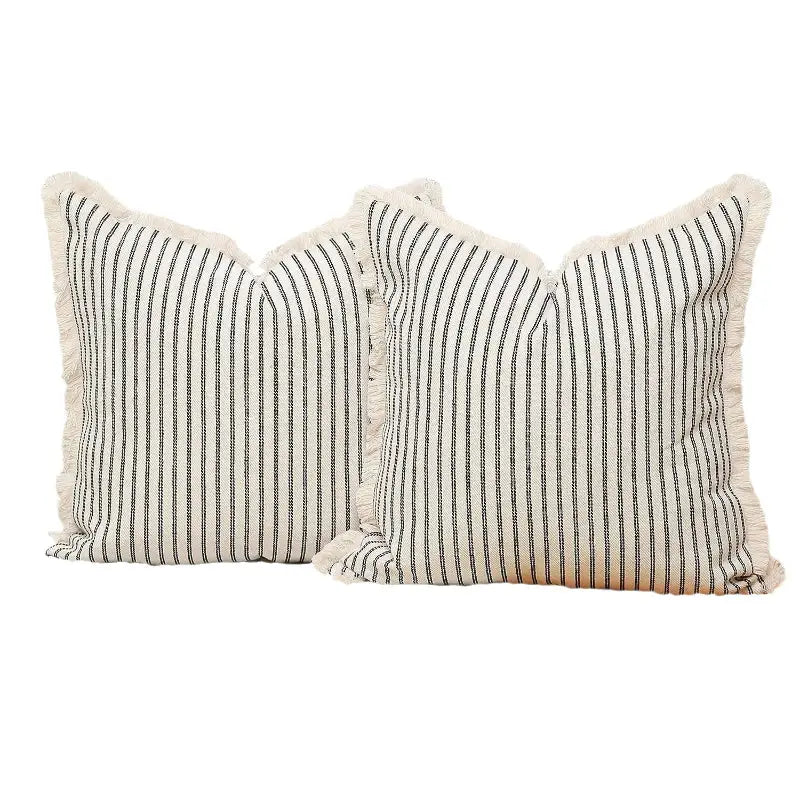 Yarn-dyed wool cushion with two striped throw pillows featuring fringe for cozy decor